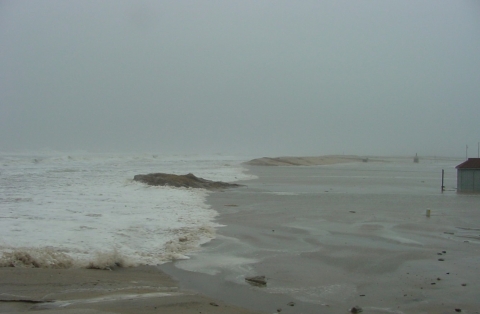Tom's Cove parking lot after storm damage. The Atlantic Ocean has broken through the dunes and flooded the area completely.