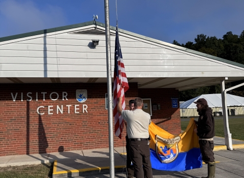 2 people raising flags