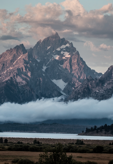 Clouds surround the major peaks of the Teton Range over Jackson Lake and Willow Flats.