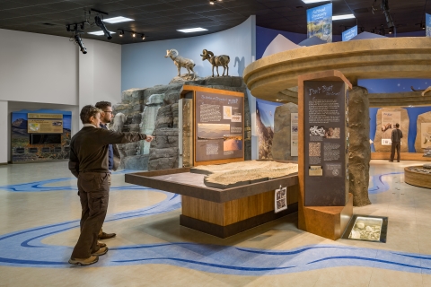 Ranger pointing to a map inside a visitor center
