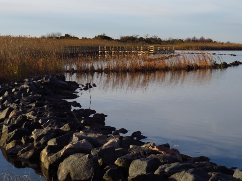 A rock breakwater and trail platform extends into and over Back Bay.