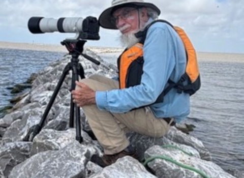 Coastal Program Biologist photographing birds from a new breakwater at Dressing Point Island in East Matagorda Bay on the Texas coast