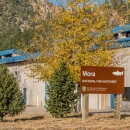 An exterior view of the Mora National Fish Hatchery building and sign.