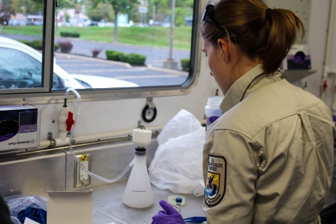 Filtration of an eDNA sample inside a mobile eDNA laboratory.