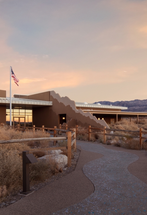 Front of Corn Creek Visitor Center at Desert National Wildlife Refuge. Mountains visible in the distance.