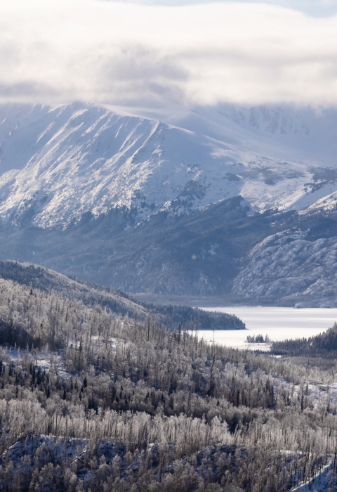 mountains and a lake with snow atop