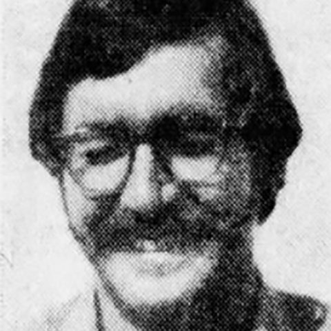 A black and white headshot of a Beau W. Sauselein smiling