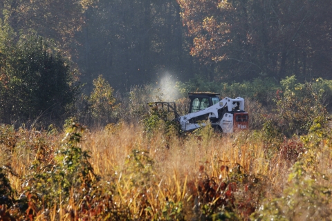 Refuge staff mowing grasslands