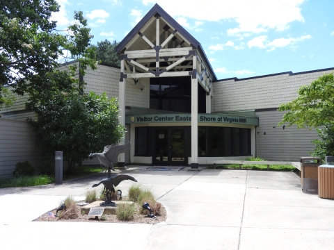 The front of the visitor center with a metal statue of two geese in the foreground