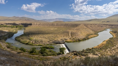 A photo overlooking the Great Basin sagebrush landscape featuring the Truckee River flowing through a riparian area.