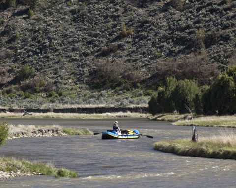 An individual in a raft on a river