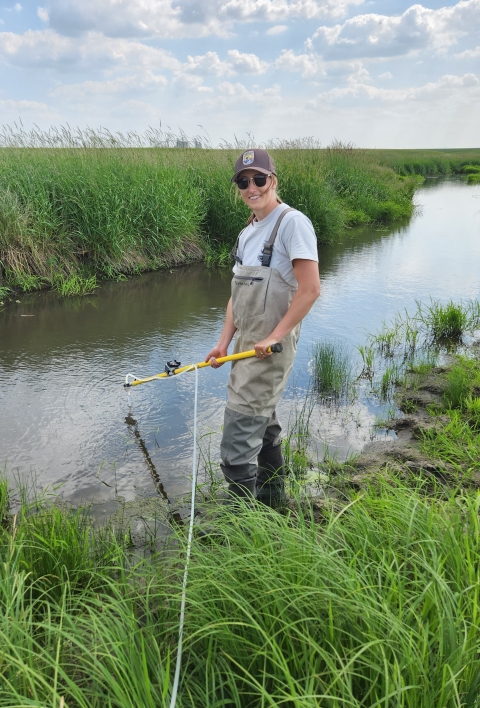Fish biologist, Jenna, collects eDNA samples for a study aimed at determining the most efficient method for detecting the Topeka Shiner.
