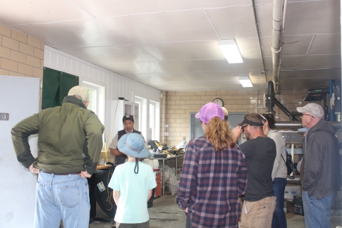 People standing listening to a Service employee wearing refuge browns.
