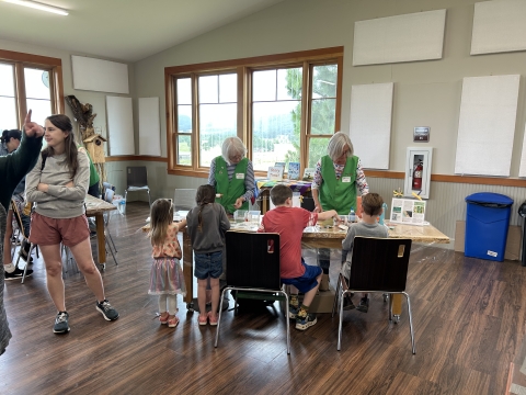 Ankeny Hill Nature Center volunteers assisting students with a craft