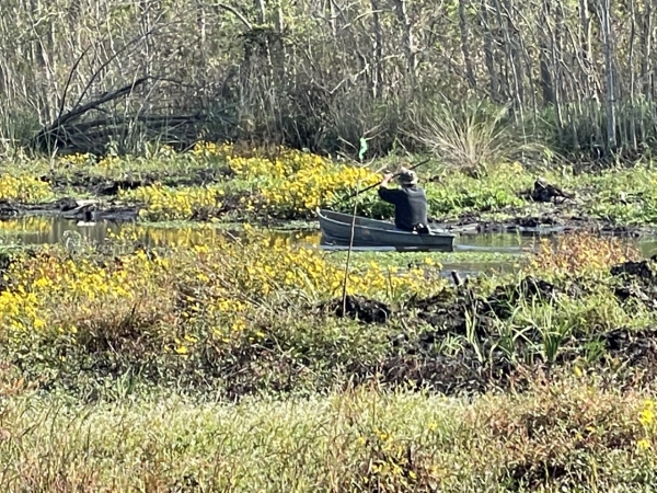 Man paddling small boat called a pirougue 