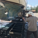 man cleans a boat