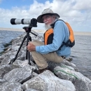 Coastal Program Biologist, Woody Woodrow, photographing birds from a new breakwater constructed to protect Dressing Point Island in East Matagorda Bay on the Texas coast.