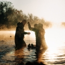 Waterfowl hunters in waders set up duck decoys in a North Carolina Wetland