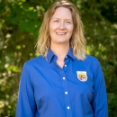 Female standing, wearing a blue shirt
