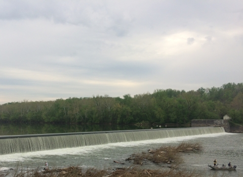 Dam along the Potomac River with a small boat in the water