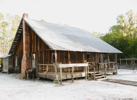 An image of the historic Chesser Island Homestead, a log cabin built by Tom Chesser in 1927.