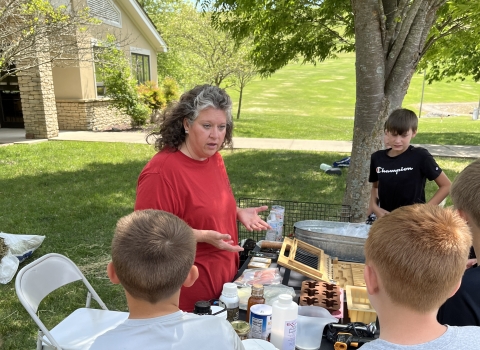 Presenter teaching kids at a booth